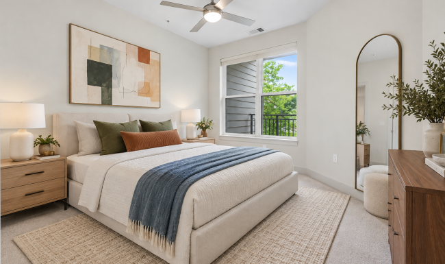 Bright bedroom in a Herndon, VA apartment at The Ian, with large windows, a ceiling fan, and room for a king-size bed