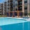 pool with reclining seats and lush landscaping