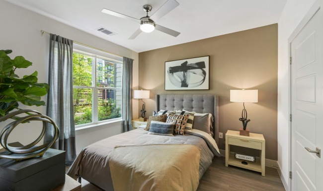 Bedroom Spacious bedroom with large window. Hardwood style flooring throughout.